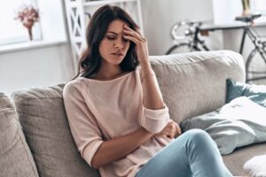 Woman experiencing pregnancy symptoms, headache